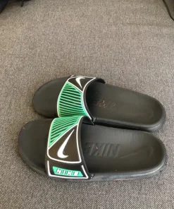 Black and green Nike slides